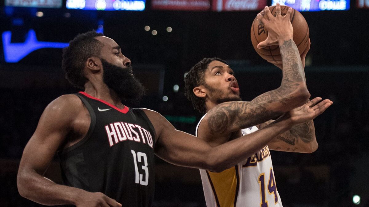 Los Angeles Lakers forward Brandon Ingram goes up for a basket as Houston Rockets guard James Harden defends him during the second half.