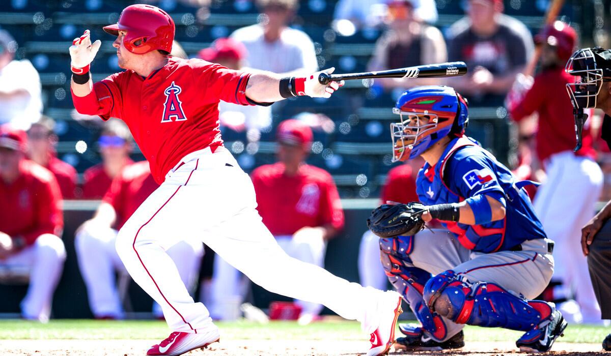 Angels outfielder Daniel Robertson bats during a 7-3 spring training game lost to the Texas Rangers on Friday.