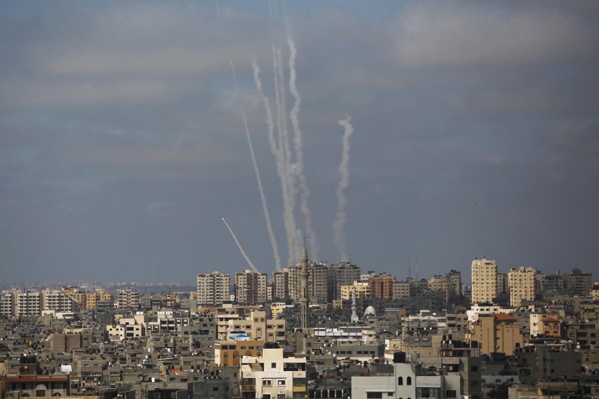 Trails from rocket launches above Israeli cityscape