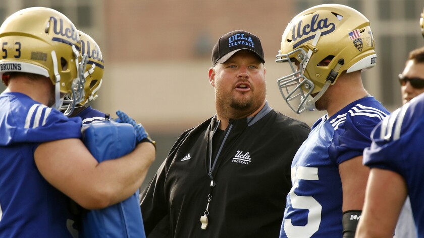 UCLA offensive line coach Hank Fraley works with his linemen during spring practice in April.