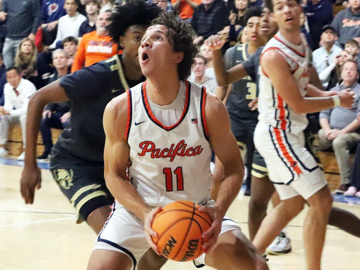 Pacifica Christian's Logan Stewart (11) finds an opening for a shot under the basket against St. Francis on Wednesday night.