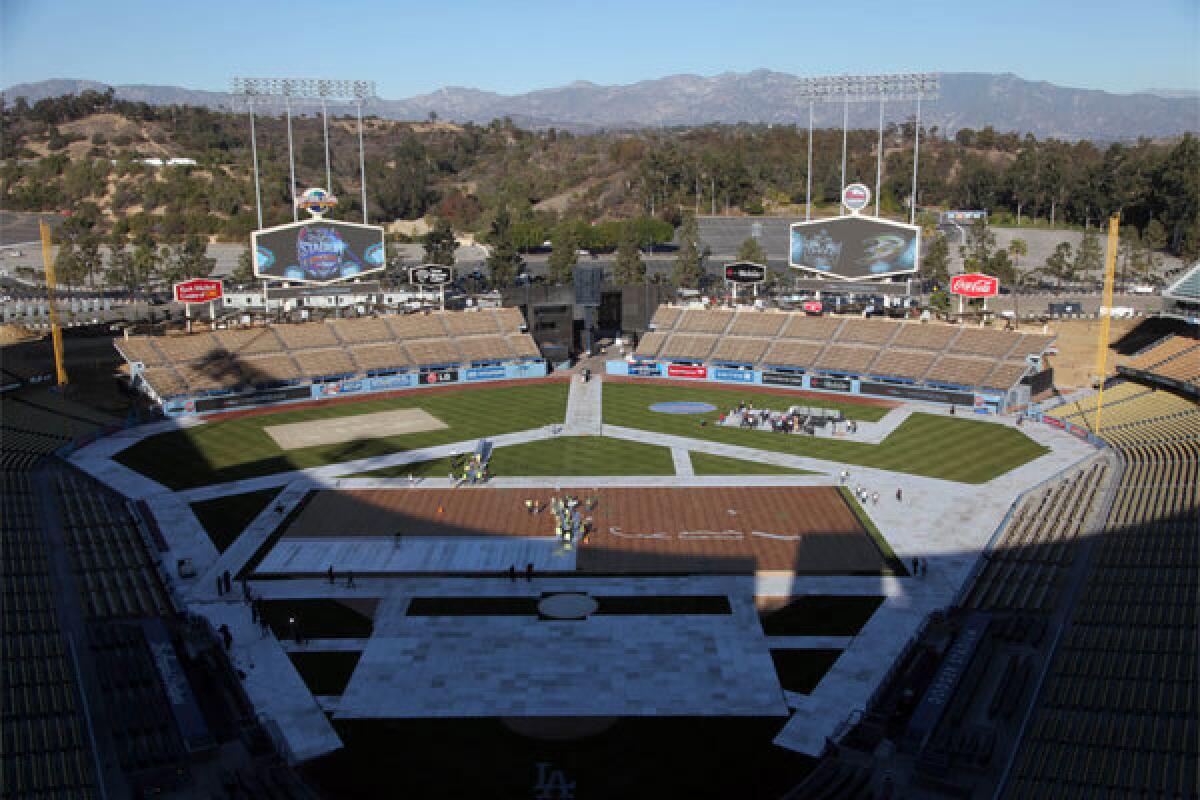 Construction workers build an ice-skating rink at Dodger Stadium in preparation for the Jan. 25 NHL game between the Kings and Ducks.