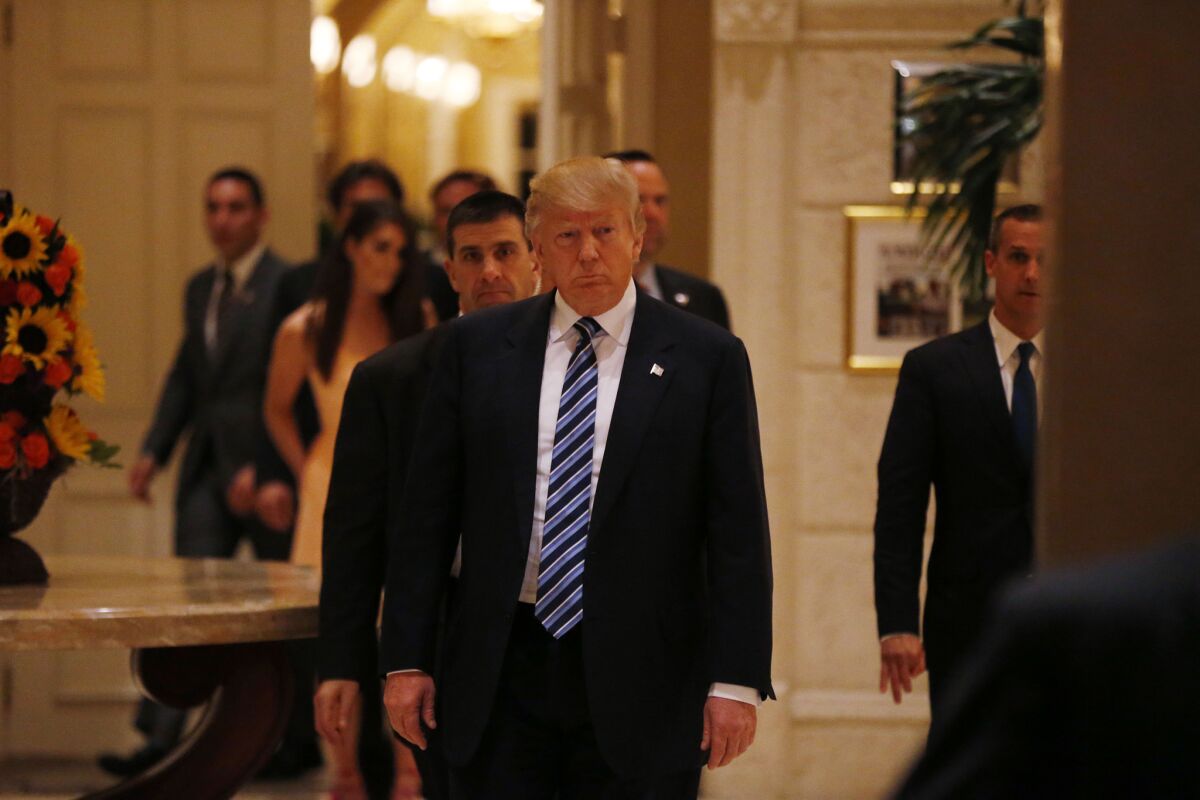 Republican presidential candidate Donald Trump walks Saturday through the Trump International Golf Club in West Palm Beach, Fla., where he held an evening news conference after winning party contests in Louisiana and Kentucky and losing in Maine and Kansas.