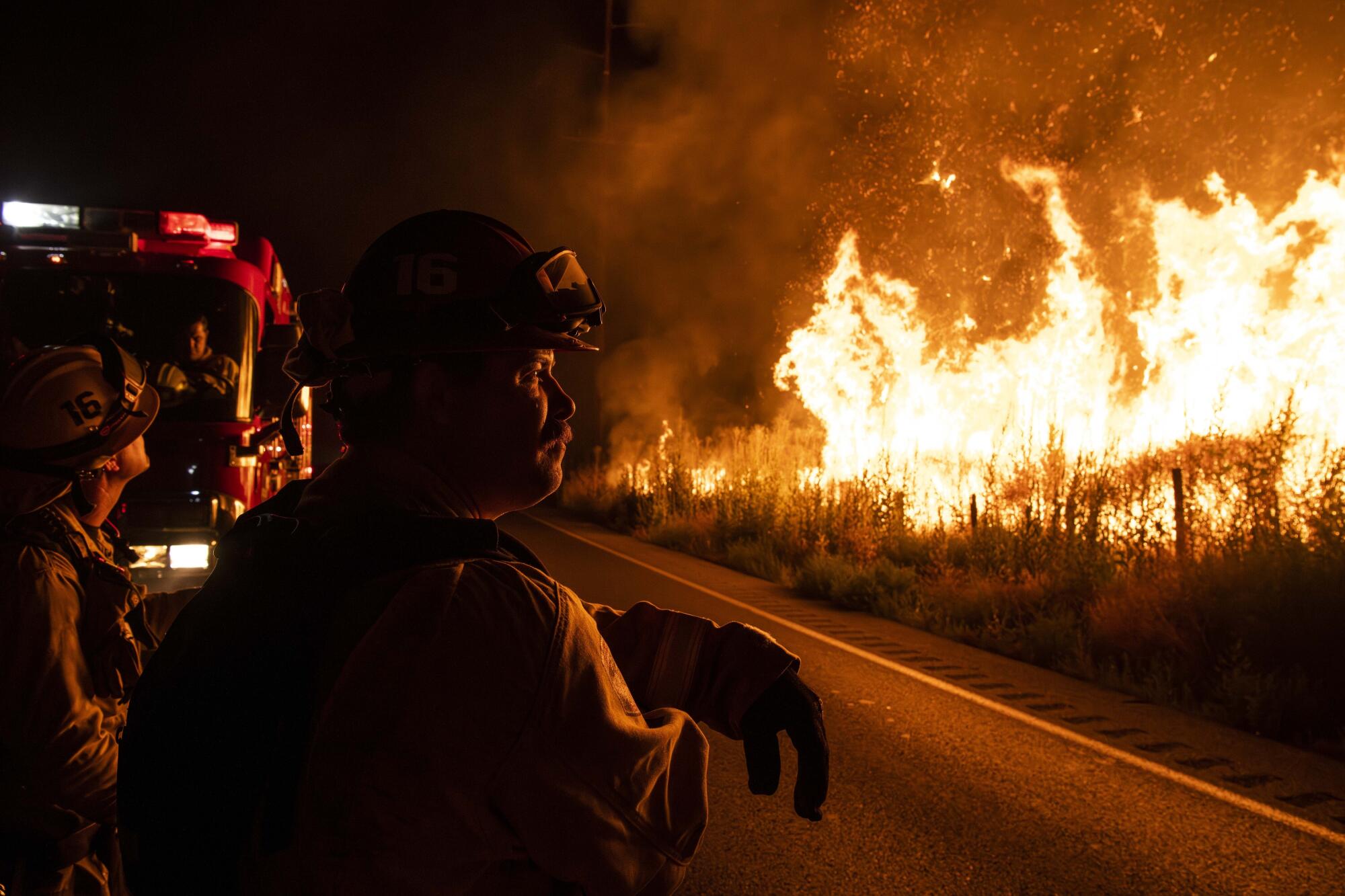 CalFire (California Department of Forestry and Fire Protection) firefighters watch the Rabbit Fire