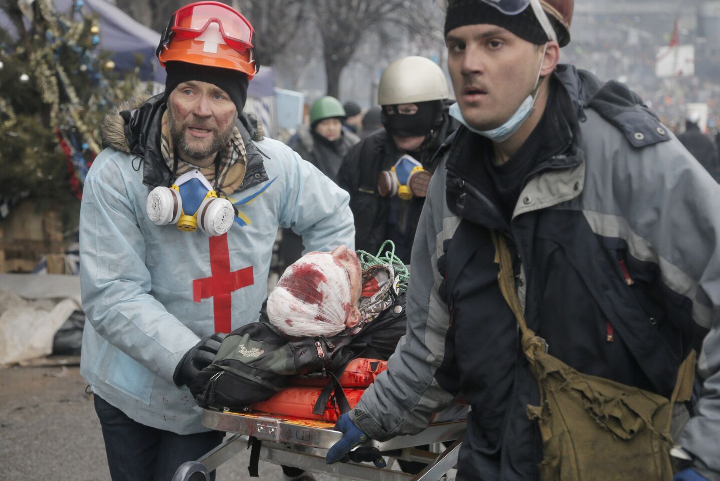 A wounded Ukrainian protester is evacuated during clashes with police in Kiev's Independence Square.