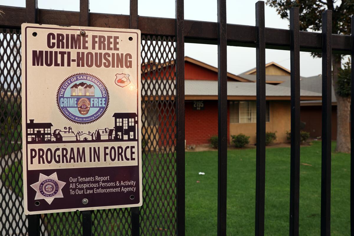An apartment complex in San Bernardino displays a crime-free housing sign on its gate in September.