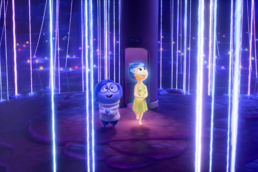 This image released by Disney/Pixar shows, from left, Sadness, voiced by Phyllis Smith, left, and Joy, voiced by Amy Poehler, in a scene from "Inside Out 2." (Disney/Pixar via AP)