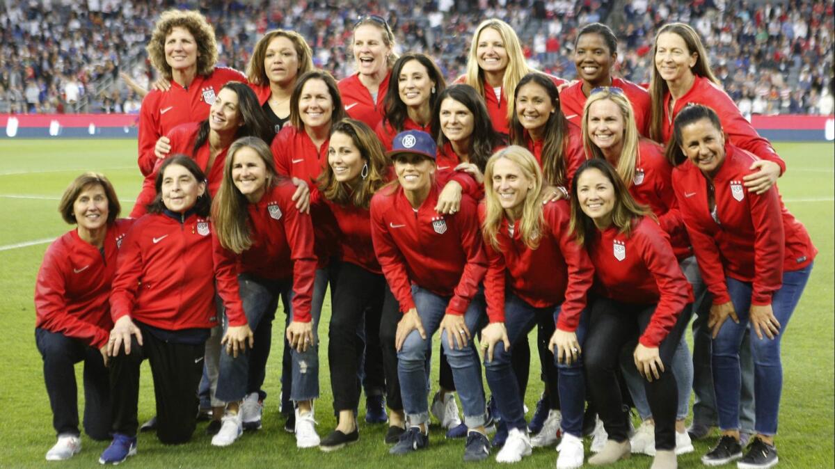 Members of the 1999 U.S. Women's National Team gather for a group photo during a match between the current U.S. women's squad and Belgium in April.