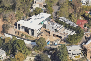 The three-story home sits on a knoll overlooking the Sunset Strip.