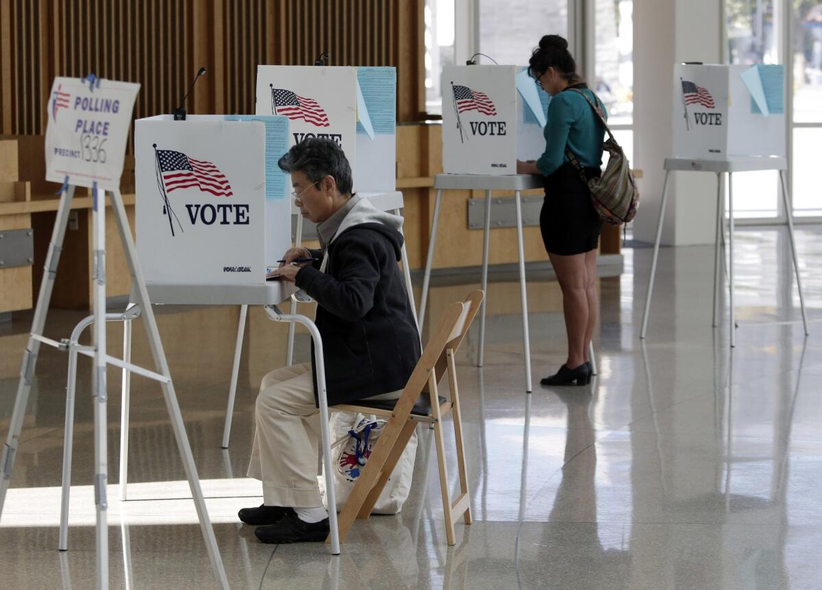 Voters at a polling place inside City Hall Nov. 4 in San Jose. Community leaders said possible errors in translations for Vietnamese voter guides may affect the way citizens vote for Proposition 46, a statewide ballot measure seeking to require drug testing of doctors.