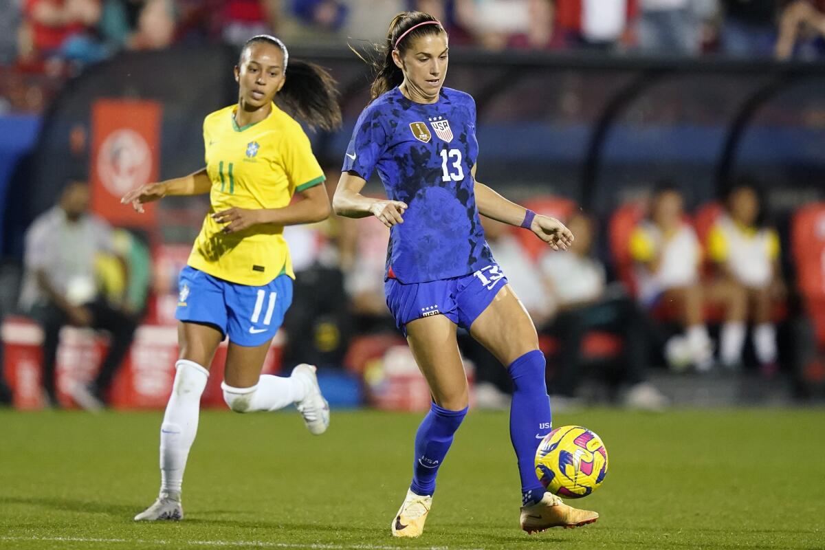 U.S. forward Alex Morgan controls the ball in front of Brazil midfielder Adriana during the SheBelieves Cup 