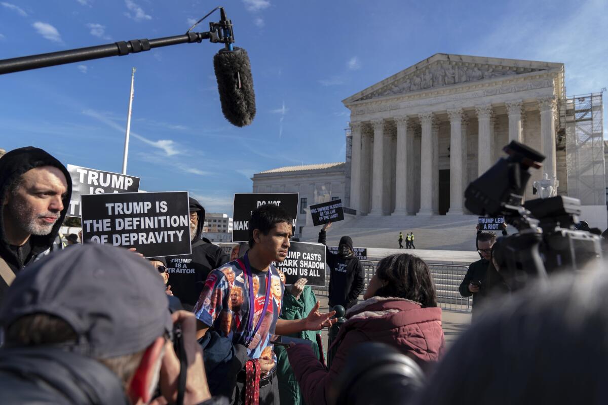 Gabriel Chambers, wearing a Trump t-shirt, is interviewed outside of the U.S. Supreme Court, Thursday, Feb. 8, 2024, in Washington. The U.S. Supreme Court on Thursday will take up a historic case that could decide whether Donald Trump is ineligible for the 2024 ballot under Section 3 of the 14th Amendment. (AP Photo/Jose Luis Magana)