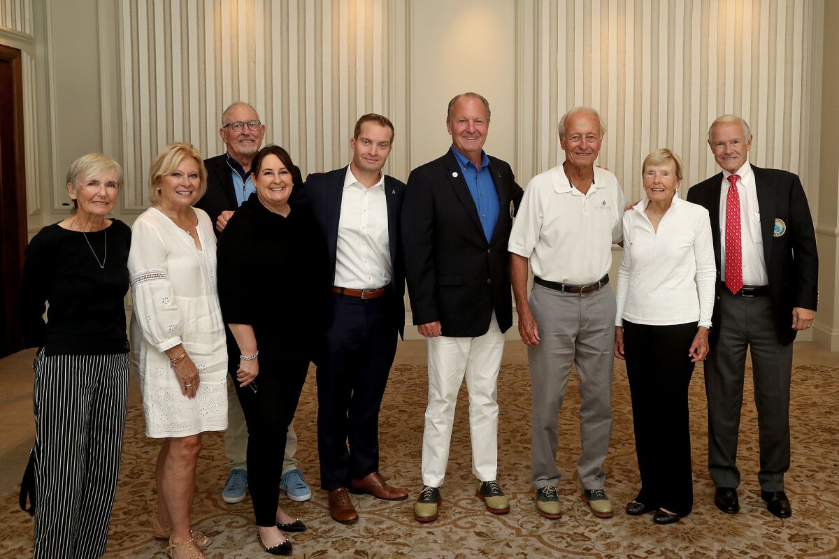 This year's Newport Beach Citizen of the Year David Beek, fourth from right, smiles for photos.