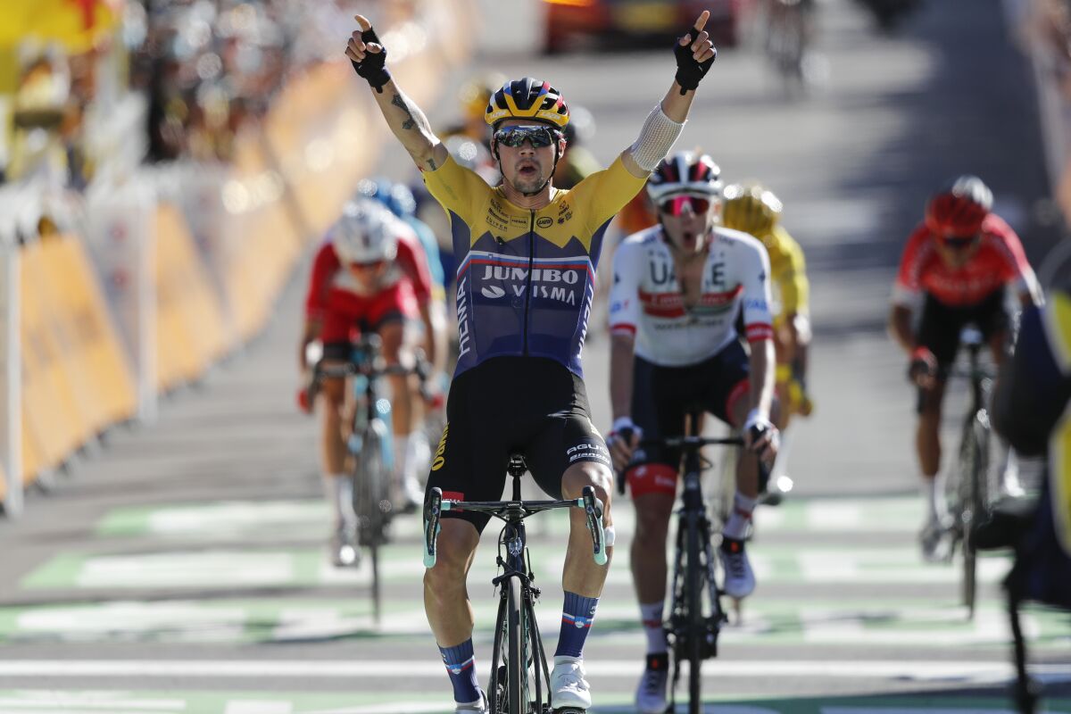 Primoz Roglic celebrates as he crosses the finish line to win the fourth stage of the Tour de France.