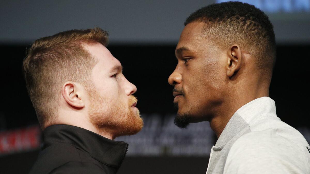 Canelo Alvarez, left, and Daniel Jacobs pose for photographers at a news conference May 1 in Las Vegas.