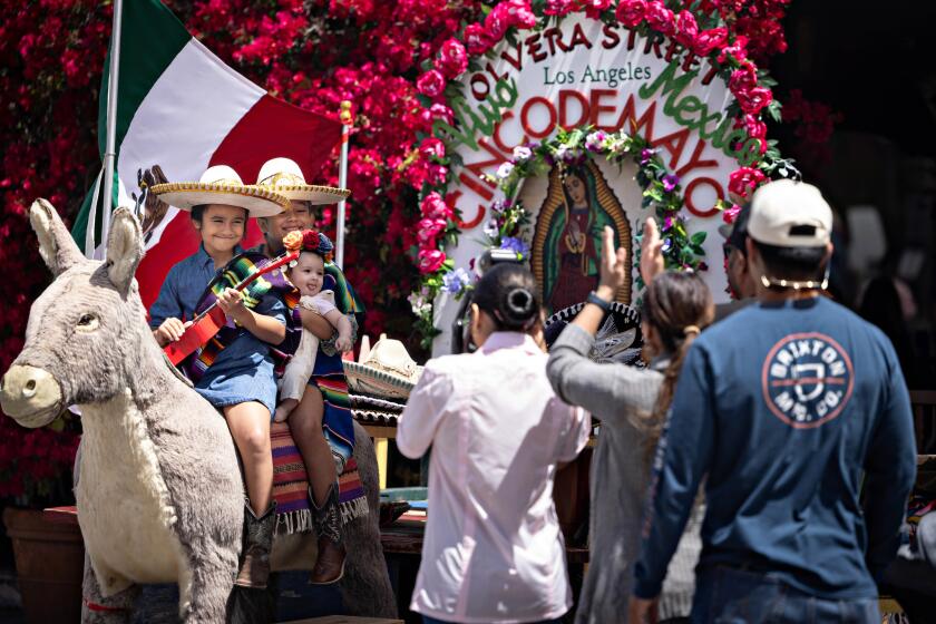 Los Angeles, CA - May 05: Families enjoy Jorge, the stuffed burro of Olvera Street during Cinco De Mayo Fiesta at Olvera Street on Sunday, May 5, 2024 in Los Angeles, CA. (Jason Armond / Los Angeles Times)