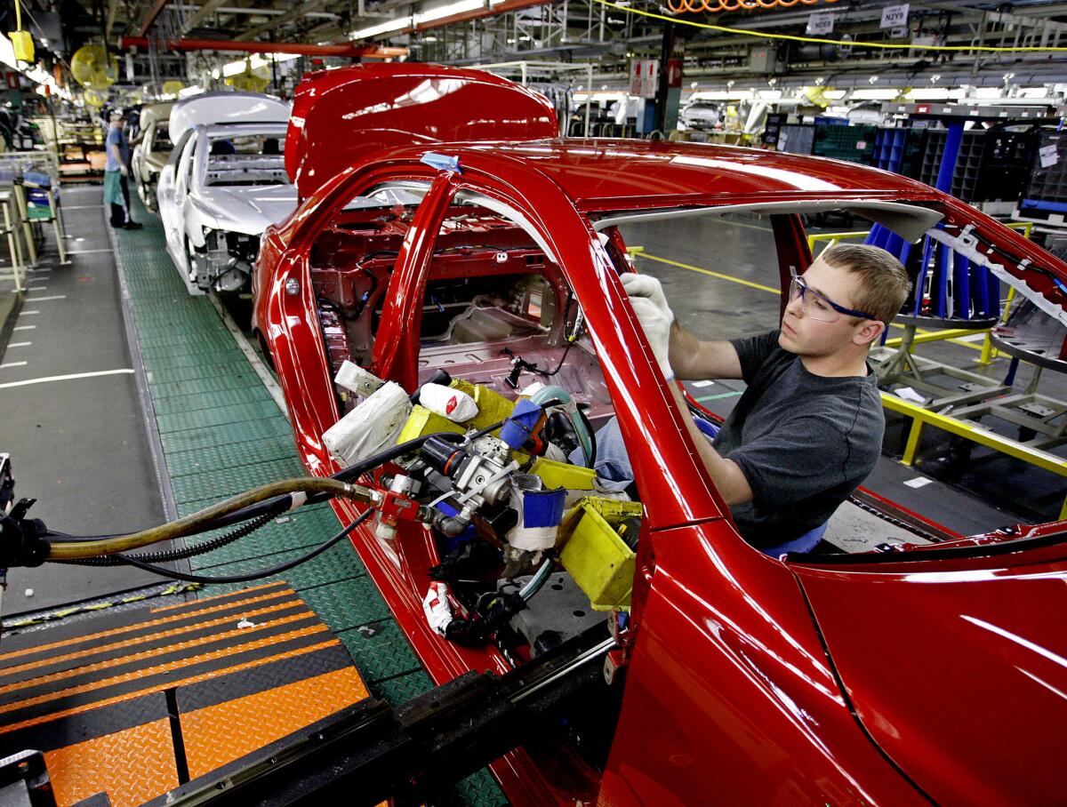 Team member Jared Carroll works inside a new Toyota Camry in the trim section at a Toyota plant in Georgetown, Ky. (Lexington Herald-Leader / MCT via Getty Images)