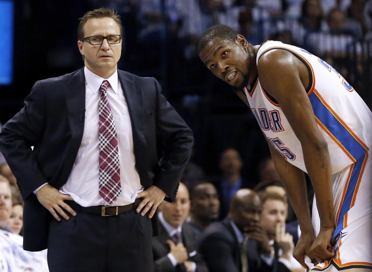 Scott Brooks talks to Kevin Durant during a break as the Oklahoma City Thunder plays at home against the San Antonio Spurs on May 31, 2014.