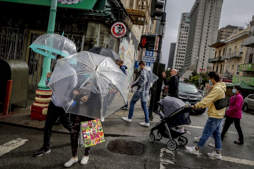Rain drenches streets in Chinatown in San Francisco, on Sunday, Sept. 18, 2022. The rainstorm is a dramatic shift of events for many residents after a record heat wave and grueling wildfire season. (Brontë Wittpenn/San Francisco Chronicle via AP)