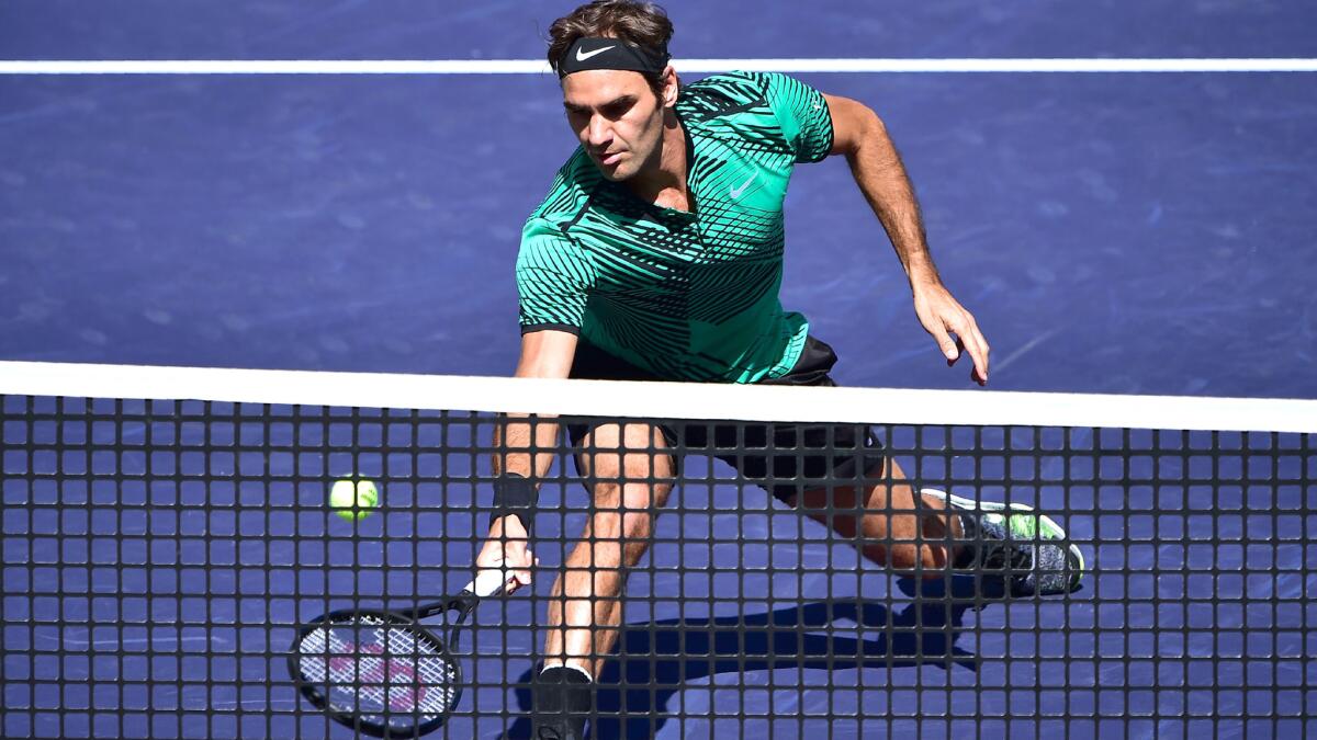 Roger Federer races to the net to make a volley during his semifinal match against Jack Sock on Saturday at the BNP Paribas Open.
