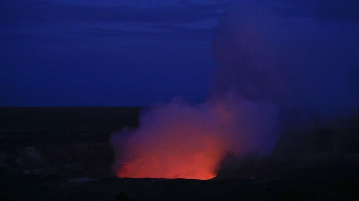 Kilauea's summit crater glows red in Volcanoes National Park in Hawaii.