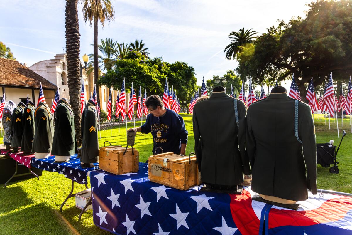 Art Hernandez sets up a display for a Veterans Day ceremony.