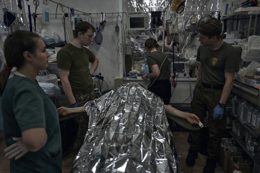 A Ukrainian wounded soldier gets the first aid at a medical stabilisation point near Bakhmut, Donetsk region, Ukraine, Monday, June 19, 2023. (AP Photo/Libkos)