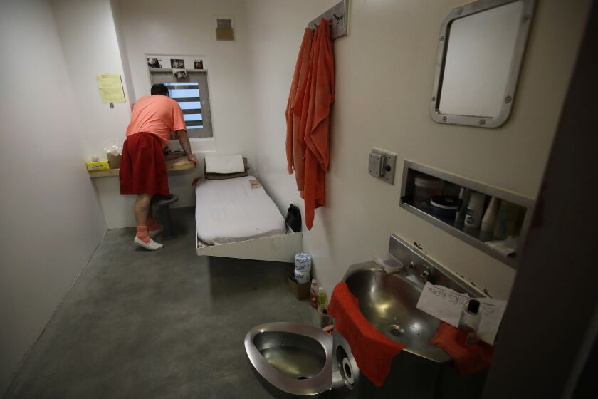 FILE - An inmate looks out a window in his solitary confinement cell at the Main Jail in San Jose, Calif., on Dec. 16, 2019. California Gov. Gavin Newsom delivered a mixed verdict on more than three dozen criminal justice laws before his bill-signing deadline on Friday, Sept. 30, 2022. (AP Photo/Ben Margot, File)