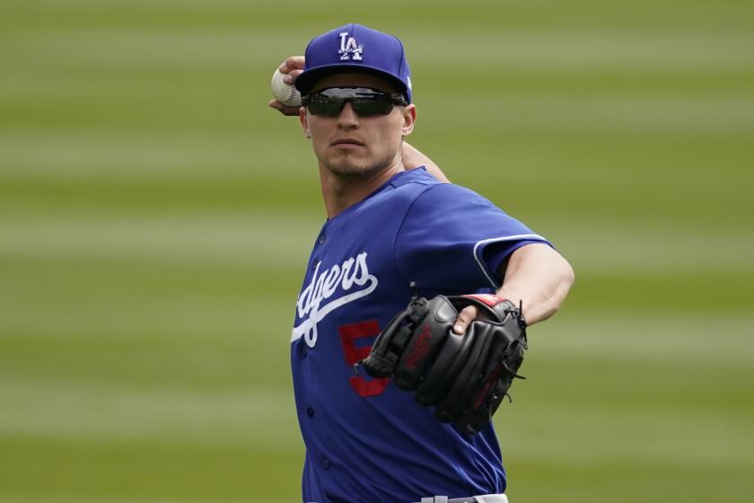 Los Angeles Dodgers shortstop Corey Seager (5) warms up before a spring training baseball game against the Colorado Rockies Monday, March 15, 2021, in Scottdale, Ariz. (AP Photo/Ashley Landis)