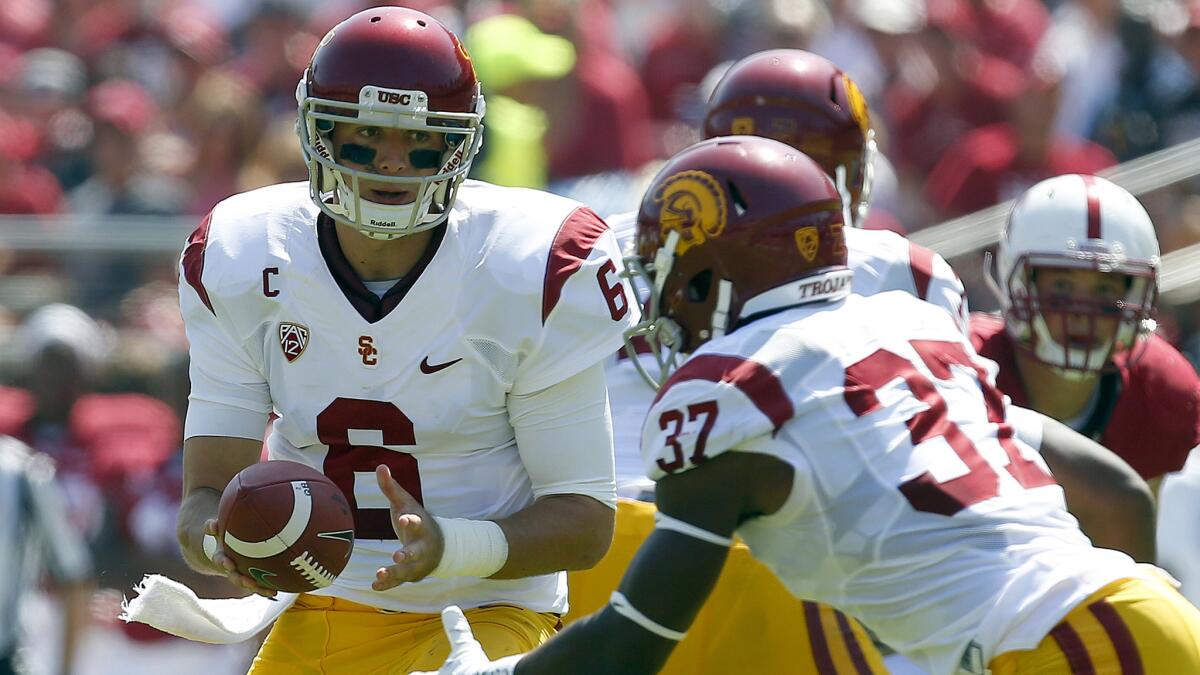 USC quarterback Cody Kessler, left, hands off the ball to running back Javorius Allen during the Trojans' 13-10 win over Stanford on Saturday.