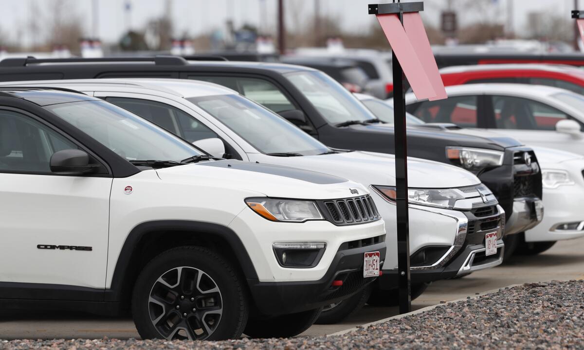 FILE - A row of unrented vehicles occupy the pickup zone for Avis car rental at the Colorado Springs Airport late Saturday, April 18, 2020, in Colorado Springs, Colo., during the coronavirus outbreak. Shares of Avis doubled on Tuesday, Nov. 2, 2021, after the rental car company's third-quarter results showed it is well on the road to recovery from the damage inflicted by the pandemic on the global travel industry. (AP Photo/David Zalubowski, File)