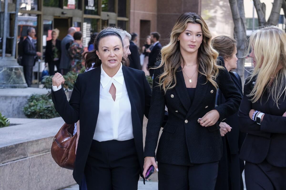 Alana Gee and her daughter, Malia, leave the Stanley Mosk civil courthouse of Los Angeles Superior Court.