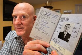 Michel Tune holds the 1940s-era Travel Document (equivalent of a passport) of his father William Tune, who fought in WWII.