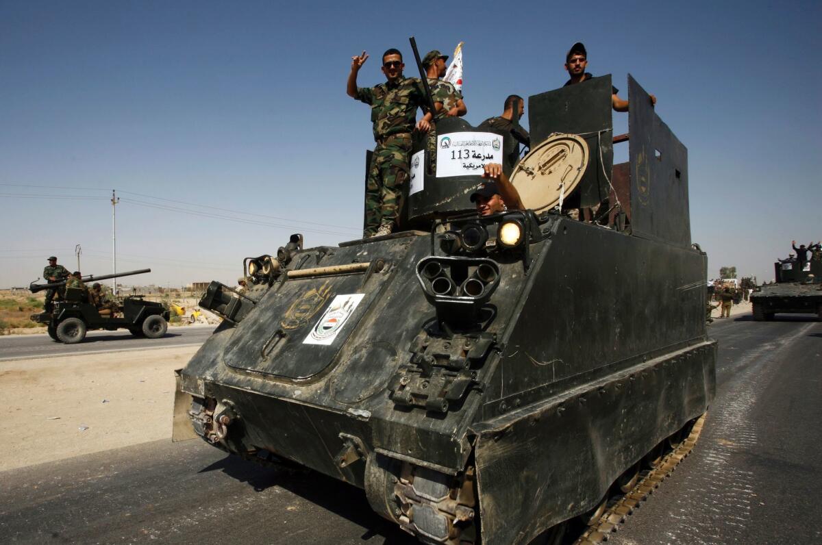 Members of the Popular Mobilization Units supporting Iraqi government forces take part in a parade of military equipment about to be mobilized in a fight to retake the Iraqi city of Mosul.