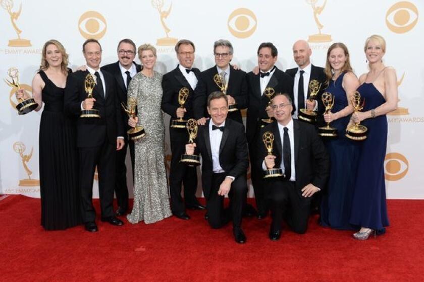 Show Creator Vince Gilligan (3rd from L), actor Bryan Cranston (C) and producers, winners of the Best Drama Series Award for "Breaking Bad" pose in the press room during the 65th Annual Primetime Emmy Awards.