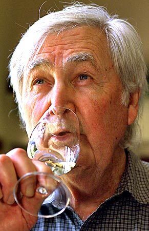 Parker, seen in 2002, tastes one of his wines. The Fess Parker Winery & Vineyards had its inaugural harvest in 1989. By 2001, wines from Parker, whose label included a tiny, gold coonskin cap, had won more than 30 medals.
