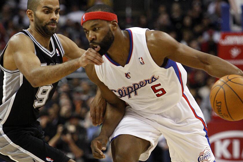 Baron Davis drives against San Antonio's Tony Parker as the Clippers play the Spurs at Staples Center on Dec. 1, 2010.