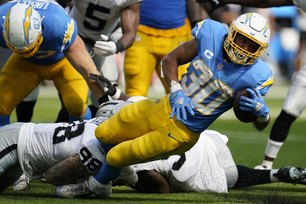 Chargers running back Austin Ekeler runs against the Raiders in Inglewood