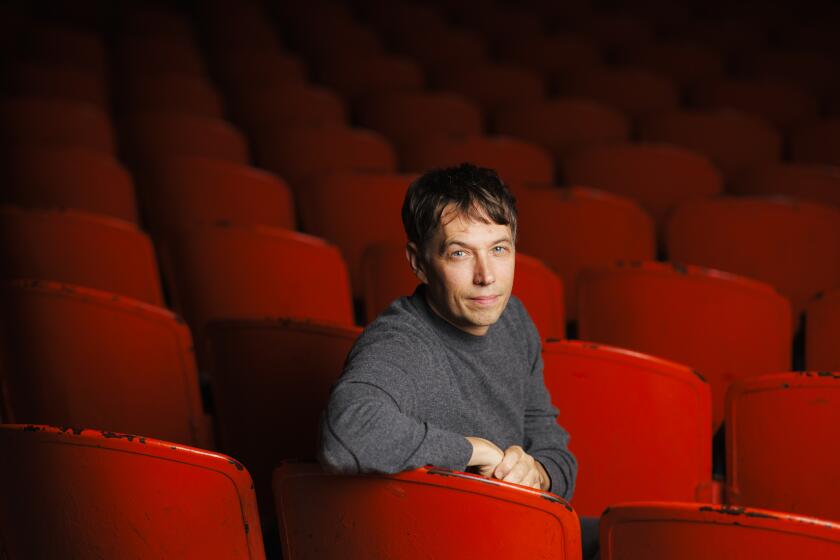 Palme d'Or-winning director Sean Baker sits inside the Gardena Cinema.