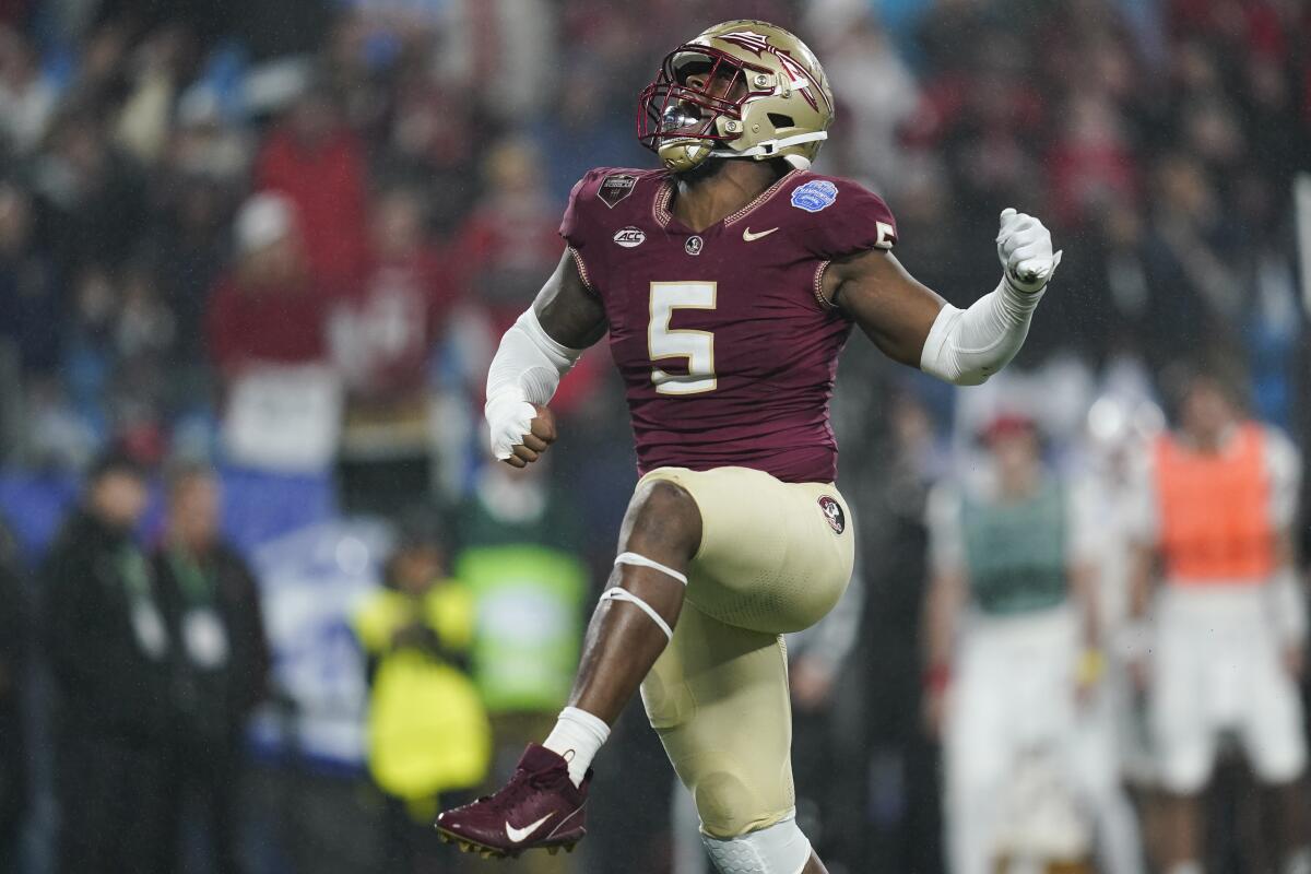 Florida State defensive lineman Jared Verse raises an arm after a play against Louisville.
