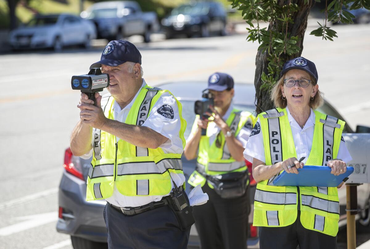 Police volunteers use radar guns to catch speeding motorists in Northridge in 2019.