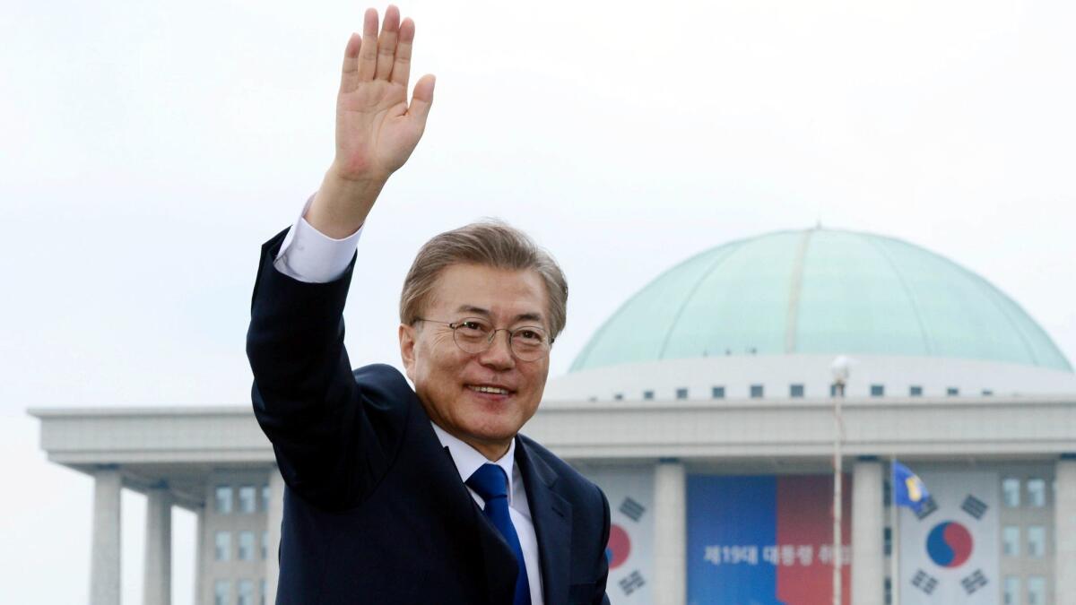 South Korea's new president, Moon Jae-in, waves from a car after his inauguration ceremony outside of the National Assembly in Seoul on May 10.