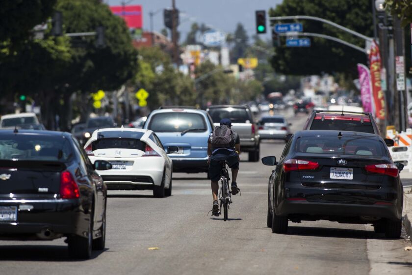 A cyclist bikes up North Figueroa Street between Avenue 52 and Avenue 56 in Highland Park on July 16, 2014.