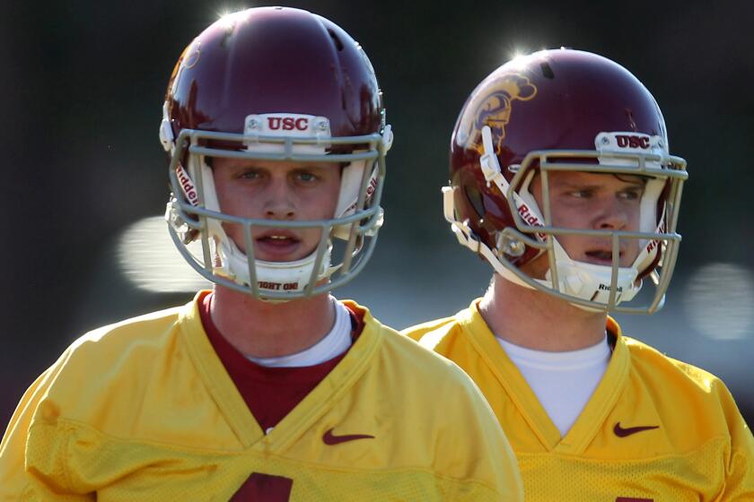 USC quarterbacks Max Browne, left, and Sam Darnold take snaps on the first day of spring practice on March 8.