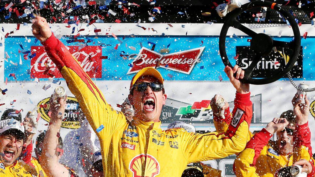 NASCAR driver Joey Logano celebrates in victory lane while holding his steering wheel after winning the Daytona 500 on Feb. 22, 2015.