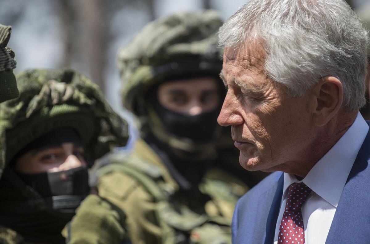 Secretary of Defense Chuck Hagel speaks with Israeli soldiers during a visit to a military canine unit training site at a base near Tel Aviv.
