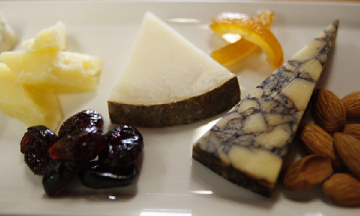 Cheese, dried sour cherries, orange peels and almonds are served up at California Wine and Cheese in Monrovia, Calif.