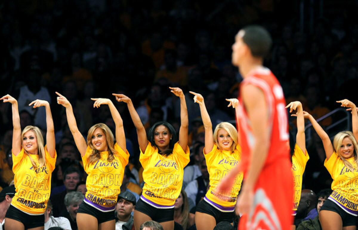 Laker girls point to the bench after a Rockets player fouled out during a game at Staples Center.