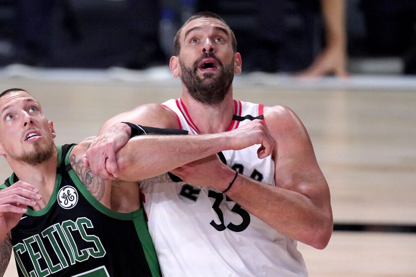 Boston Celtics' Daniel Theis (27) and Toronto Raptors' Marc Gasol (33) struggle.
