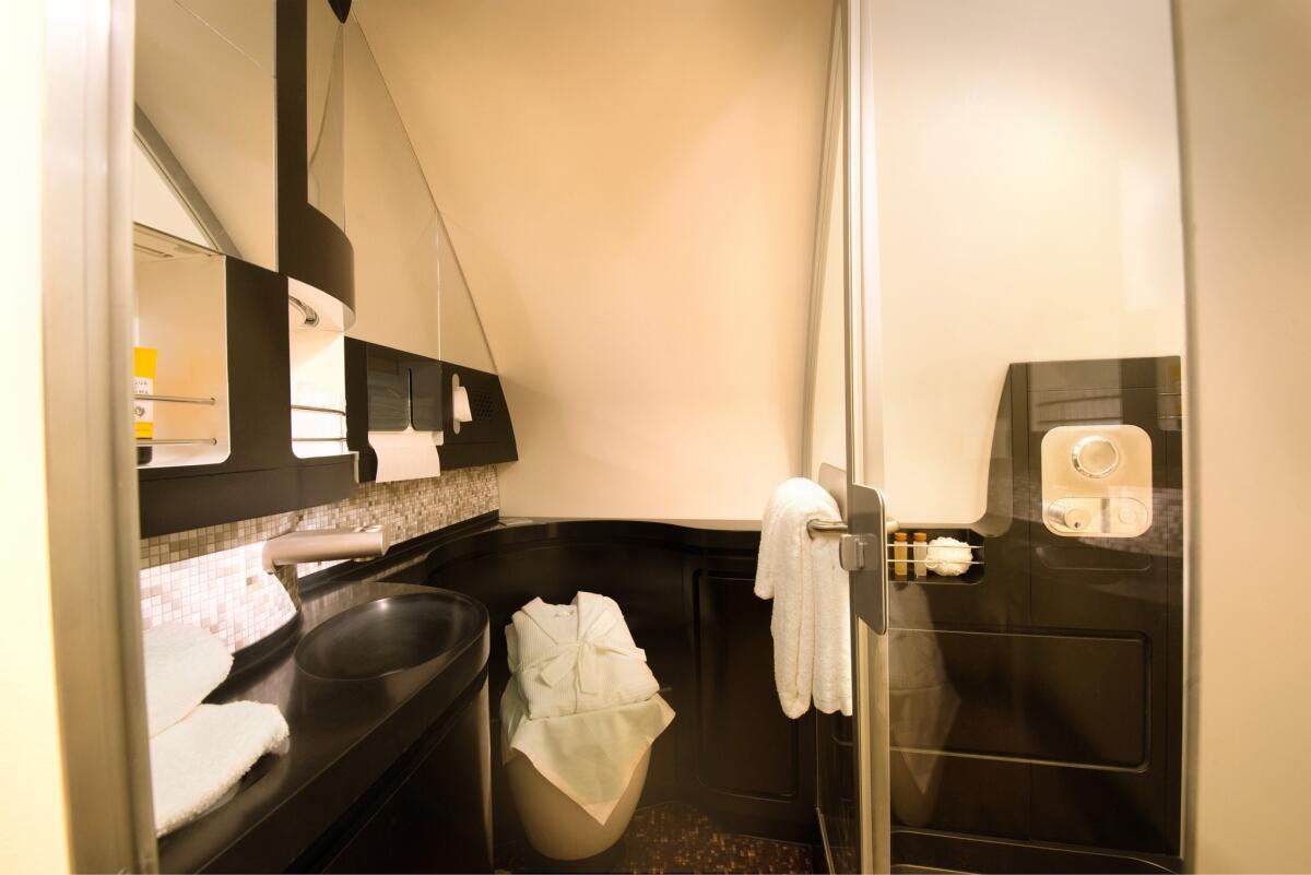 Etihad Airways is offering a three-room cabin on its Airbus A380 planes that includes the bathroom shown here. A butler is included in the fare.